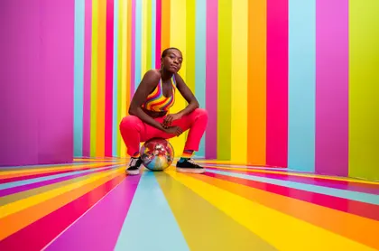 Crouching Woman In Rainbow Stripe Studio — 198-piece jigsaw puzzle
